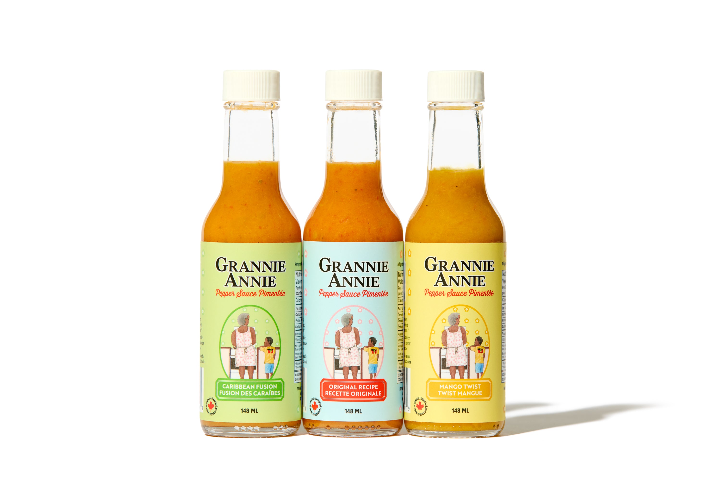 Three bottles of Grannie Annie hot sauce on a white background